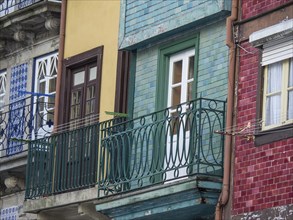 Facades of houses with colourful balconies, clotheslines and windows, old houses in the old town of