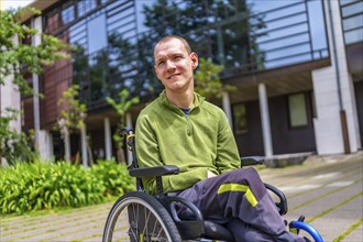 Close-up portrait of a proud man with cerebral palsy in the university campus looking up