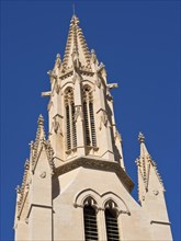 Gothic church tower in front of a blue sky, palma de mallorca on the mediterranean sea with its