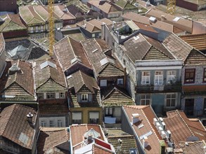 Tightly packed houses with red tiled roofs and windows that characterise the city panorama, old