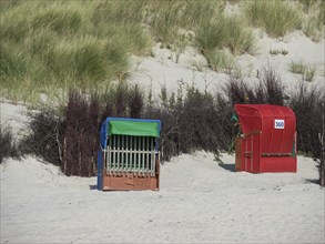 Two beach chairs in the sand in front of dunes with vegetation, Heligoland, Germany, Europe