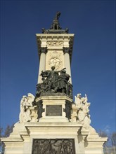 Imposing equestrian statue with detailed reliefs on a tall monument, Madrid, Spain, Europe