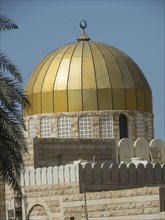 A golden dome on a mosque building with a clear blue sky in the background, Abu Dhabi, United Arab