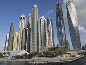 Panoramic shot of numerous tall buildings and skyscrapers in clear weather conditions, dubai, arab