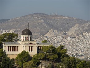 Historic building with a dome on a hill surrounded by trees and urban landscape, Ancient building