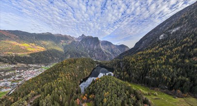 Aerial view, mountain peaks of the Oetztal Alps reflected in Lake Piburger See, in autumn, near