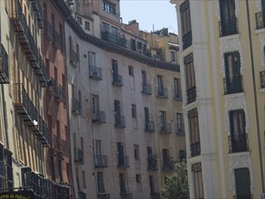 Narrow street scene with rows of historic buildings, Madrid, Spain, Europe