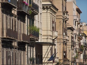 Urban street with elegant facades and balconies under a clear sky, palermo in sicily with an