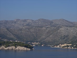Hilly coastal landscape with scattered houses and peaceful sea views, the old town of Dubrovnik