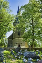 Erratic boulder garden in front of the village church in Schwarz, Mecklenburg Lake District,