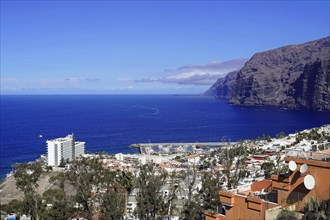 Steep coast of Los Gigantes, Canary Islands, Spain, Europe, coastal town with harbour and white