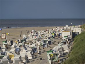 Row of beach chairs along the sandy beach, ideal for beachgoers, the north sea island of baltrum