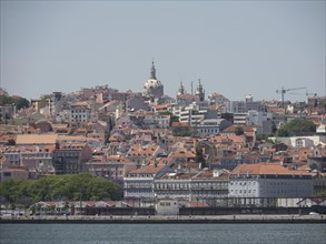 Panorama of a city with many houses and a dome in the distance, Lisbon, Portugal, Europe