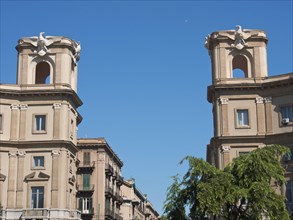 Symmetrical buildings in an urban setting under a clear blue sky, palermo in sicily with an