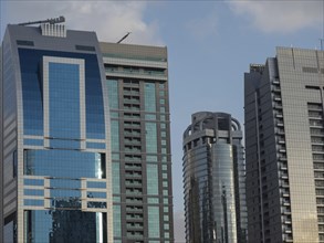 Detailed modern skyscrapers with glass facades against a bright sky, Dubai, Arab Emirates