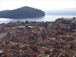 Panoramic view of a historic coastal town with red roofs, the old town of Dubrovnik with historic