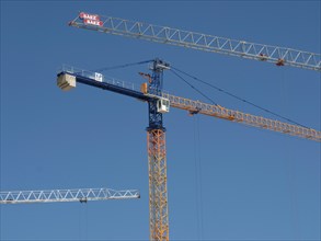 Three construction cranes towering into the blue sky, Valetta, Malta, Europe