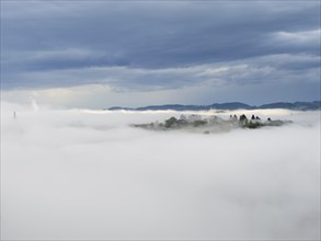 Morning fog over the village of Frauenberg, view from Silberberg, near Leibnitz, Styria, Austria,