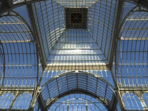 View upwards to the glass ceiling of a greenhouse reflecting in the sun, Madrid, Spain, Europe