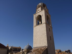 Bell tower and church dome above the roofs of a historic city, the old town of Dubrovnik with