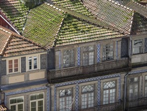 Historic buildings with green tiled roofs and decorative tiles create a harmonious and nostalgic