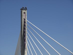 A modern bridge design with cables and a high structure under a blue sky, Lisbon, Portugal, Europe