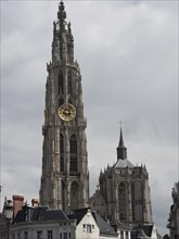 Gothic church towers rise into the grey sky of a European city, Historic buildings, Antwerp,