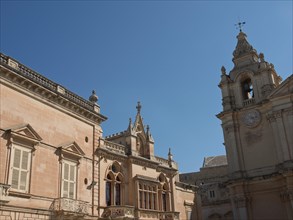 Historic buildings and a bell tower under a clear blue sky, the town of mdina on the island of
