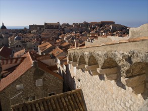 Breathtaking view over the rooftops of a medieval old town with the sea in the background, the old