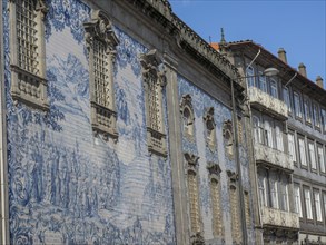 Historic building with blue tiles and ornate details on the facade and windows under a blue sky,