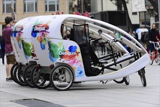 Barcelona, Catalonia, Spain, Europe, A colourfully painted bicycle tricycle for tourists in a city,