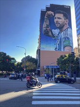 Street scene with giant mural showing Lionel Messi in winning pose, Buenos Aires, Argentina, South