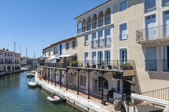 Townscape with restaurants and shops at the Pont principal du port grimaud, Port Grimaud, Var,