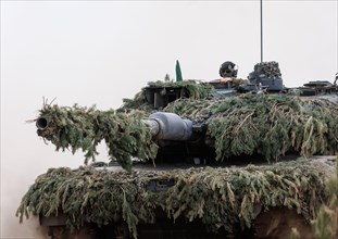 A soldier sits on a Leopard 2 main battle tank, taken during the NATO Steadfast Defender