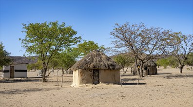 Mud huts in a village of the Hakaona, Angolan tribe of the Hakaona, near Opuwo, Kunene, Namibia,