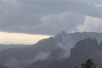 View from the goat's back in Saxon Switzerland during a thunderstorm, cloudburst, Hohnstein,