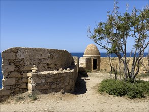 Left wall with crenellated gap for guns behind one of 10 ten round watchtowers of historic fortress