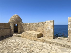 Round watchtower and wall with crenellated gap for guns one of 10 round watchtowers of historic