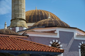 Suleiman Mosque, detailed view of historic domed building and minaret with red roofs under blue