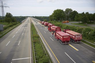 Trucks with a total weight of 960 tonnes stand on the Moselle valley bridge in Winningen during a