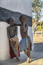 Traditional Hakaona children in their village, in the morning light, Angolan tribe of the Hakaona,