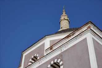 Suleiman Mosque, close-up of the upper part of a minaret and a mosque dome under a blue sky, Rhodes