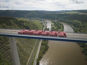 Trucks with a total weight of 960 tonnes stand on the Moselle valley bridge in Winningen during a