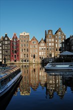 A view of Amsterdam houses by the canal in the Damark area in beautiful evening light in the month