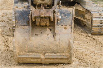 Front view of bucket on backhoe parked at rural construction site in Daejeon, South Korea, Asia