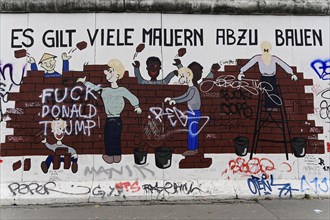 Murals of children building a wall, with political message and graffiti, murals, East Side Gallery,