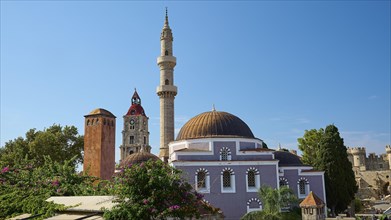 Suleiman Mosque, Historic buildings with minaret and domes, red roofs and trees under a cloudy sky,