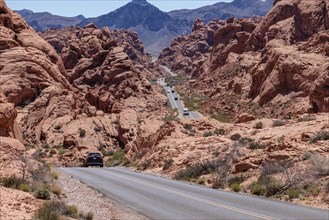 Traffic on Mouse's Tank Road winds between the red sandstone rock formations in Valley of Fire