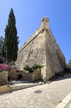 One of ten 10 round watchtowers on southern east side of ruins of historical fortress Fortetza