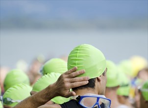 Man with a Green Bathing Cap and Swimming Goggles in a Sunny Summer Day in Switzerland